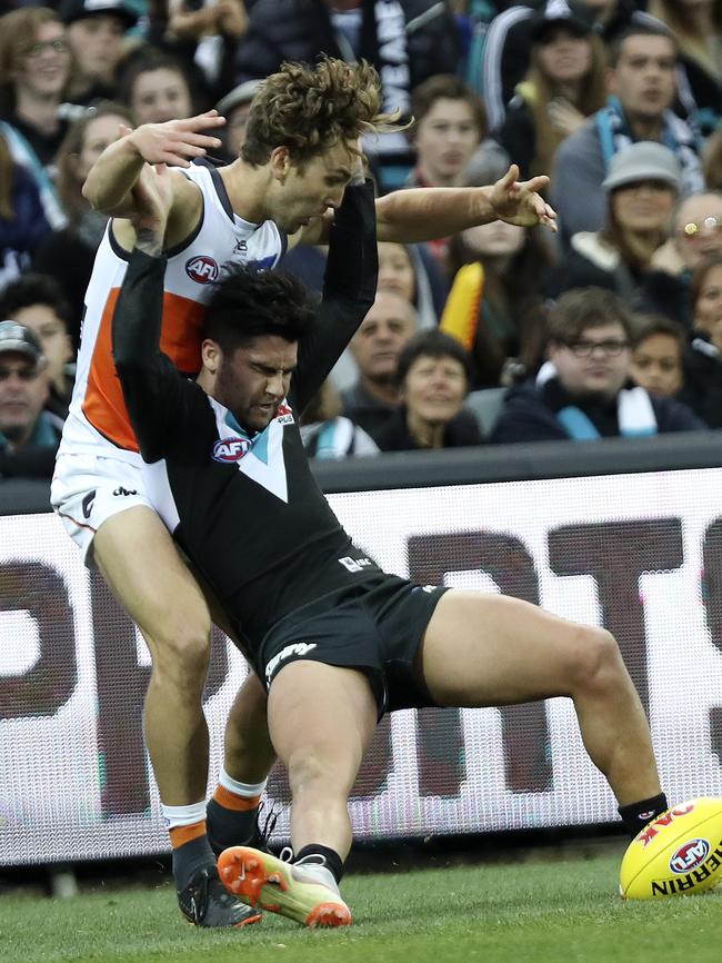 Chad Wingard crashes back into Giant Matt Buntine on Sunday. Picture Sarah Reed