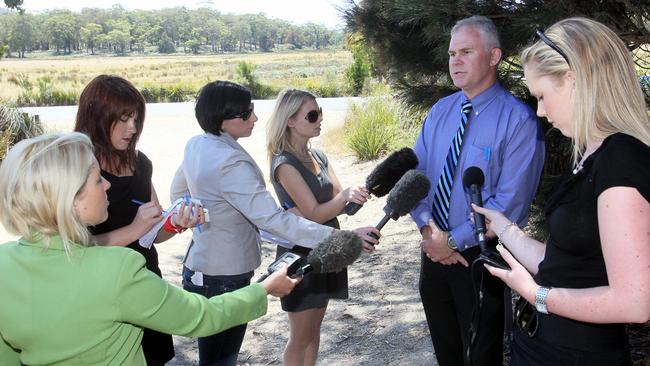 Detective Inspector Scott Flude speaking to the media as excavation work is under way at the Bicheno Tip in search of the bicycle owned by missing German backpacker Nancy Grunwaldt, who disappeared in March 1993.