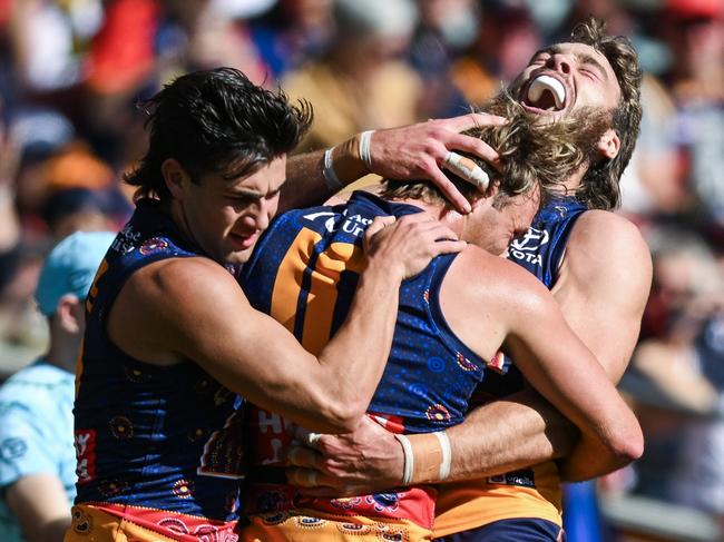 ADELAIDE, AUSTRALIA - MAY 25: Luke Pedlar of the Crows   celebrates a goal with Josh Rachele and  of the Crows  during the round 11 AFL match between Kuwarna (Adelaide Crows) v Waalitj Marawar (West Coast Eagles) at Adelaide Oval, on May 25, 2025, in Adelaide, Australia. (Photo by Mark Brake/Getty Images)
