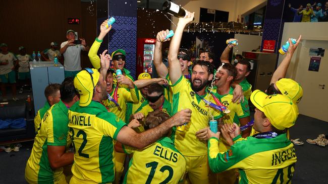 Kane Richardson, centre, leads the Australian celebrations before the squad flew home on a plane with Ashes-bound English players. Picture: Getty Images