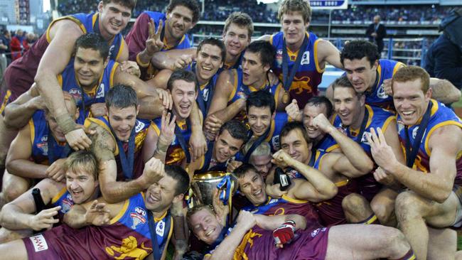 The victorious 2003 Lions celebrate their third straight AFL premiership after beating the Collingwood Magpies in the Grand Final at the MCG.