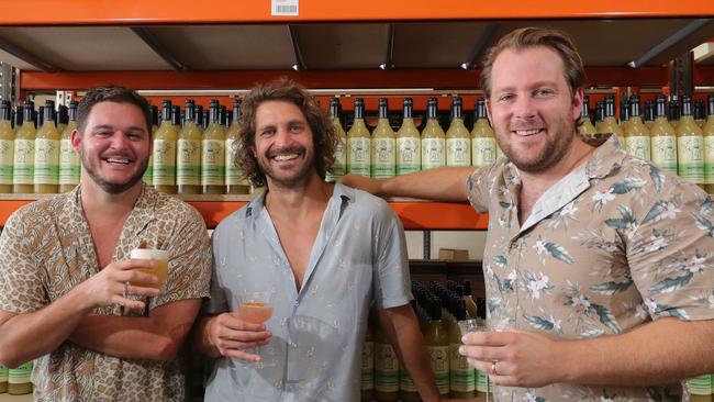 Mr Consistent owners, Jarrad Bell, Michael Sebire and Jeremy Davidson, toast the success of their ready made cocktails mix, at the company factory at Burleigh. Picture: Glenn Hampson