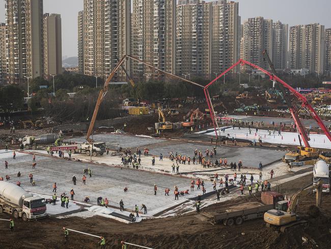 Hundreds of construction workers and heavy machinery building one of the new hospitals to tackle the coronavirus in Wuhan, China. Picture: Getty