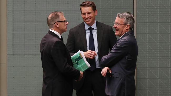 Parliamentary Joint Committee on Intelligence and Security members Anthony Byrne, Andrew Hastie and Mark Dreyfus talking in the House of Representatives Chamber, Parliament House in Canberra. Picture Kym Smith