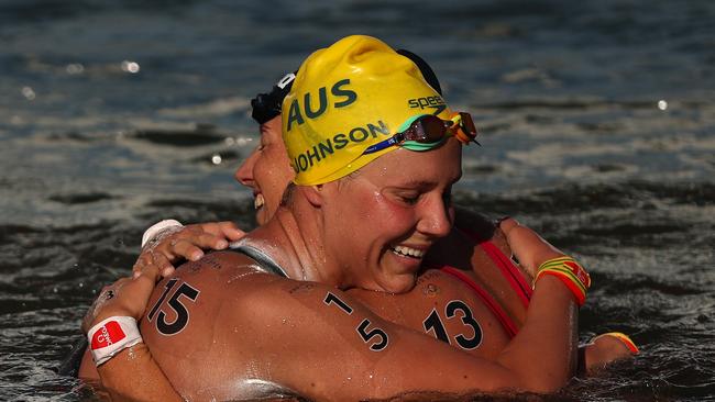 PARIS, FRANCE - AUGUST 08: Moesha Johnson of Team Australia and Ginevra Taddeucci of Team Italy celebrate after winning silver and bronze in the Marathon Swimming Women's 10k on day thirteen of the Olympic Games Paris 2024 at Pont Alexandre III on August 08, 2024 in Paris, France. (Photo by Sarah Stier/Getty Images)