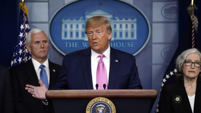 President Donald Trump with members of the President's Coronavirus Task Force, including Vice-President Mike Pence, left. Picture: AP