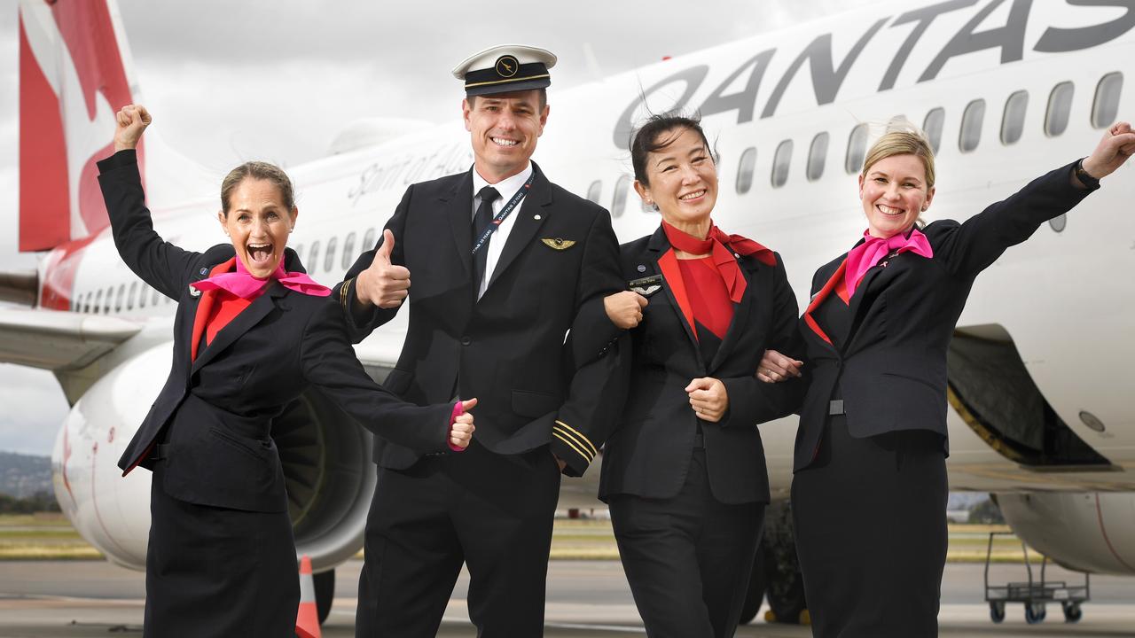 A Qantas flight crew celebrating getting back in the air in November 2021. Picture: Tricia Watkinson