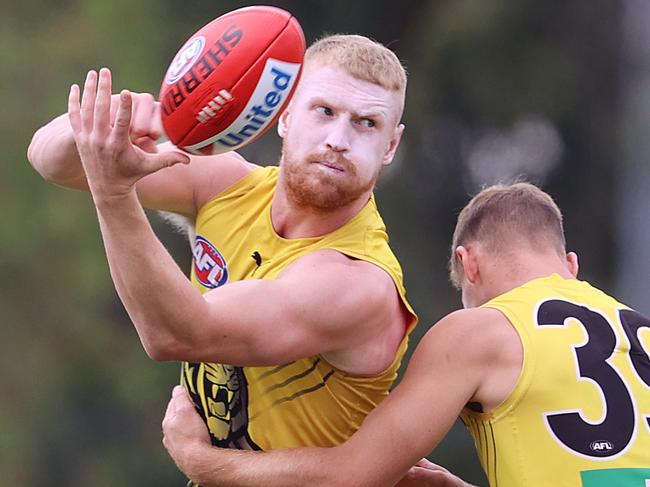 Richmond training at Metricon Stadium....  30/09/2020. Josh Caddy of the Tigers clears by hand at training today  . Pic: Michael Klein