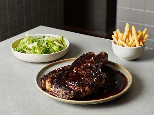 Dry aged cape grim ribeye, cooked on the bone with cos lettuce and chips.