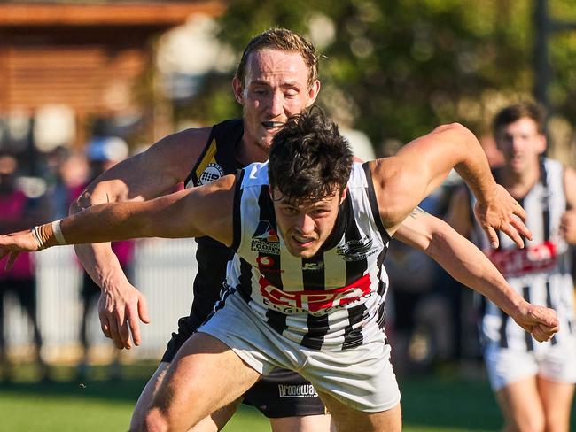 Shane Harvey chasing Cooper Young in the match between Brighton and Payneham at Brighton Oval, Saturday, April 24, 2021. Picture: MATT LOXTON