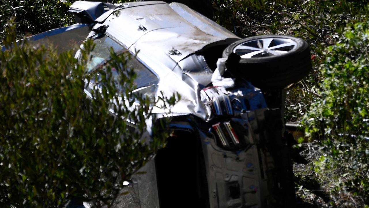 Tiger Woods car lies on its side in Rancho Palos Verdes, California, on February 23, 2021, after a rollover accident. (Photo by Patrick T. FALLON / AFP)