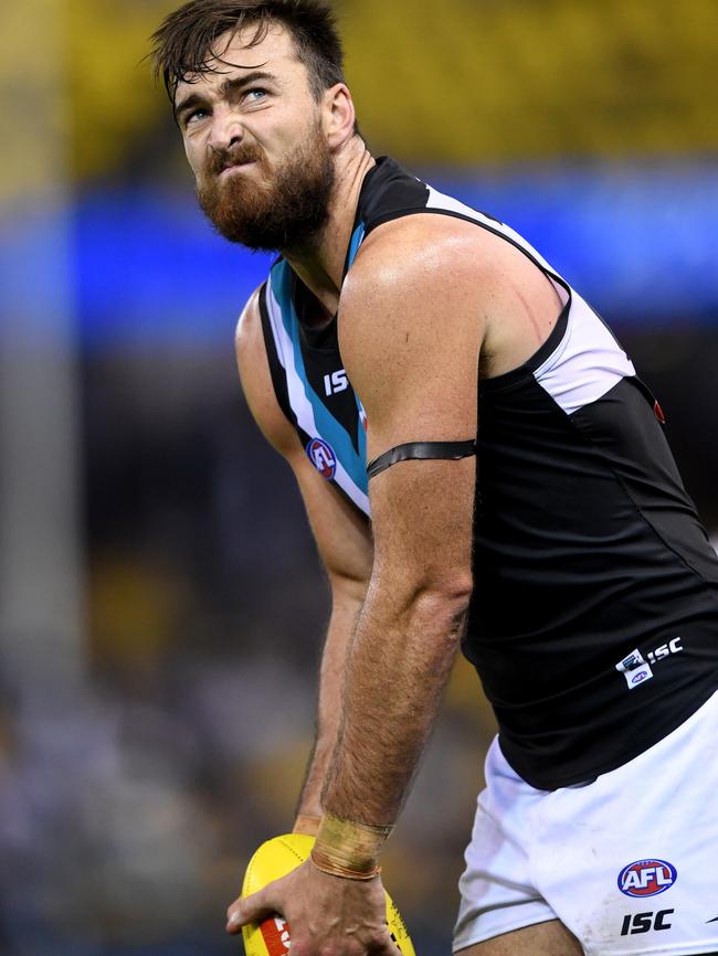 Charlie Dixon takes a glance at the scoreboard before kicking a goal against North Melbourne. Picture: AAP Image/Joe Castro