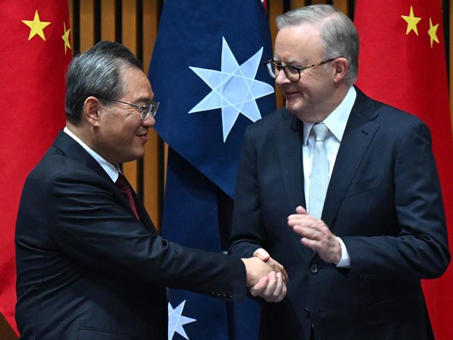 China's Premier Li Qiang (L) and Australia's Prime Minister Anthony Albanese shake hands during a signing ceremony at Parliament House in Canberra on June 17, 2024. (Photo by LUKAS COCH / POOL / AFP)