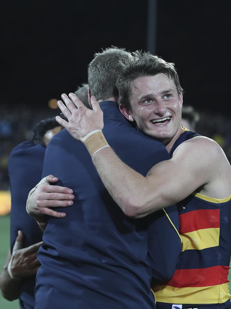 Adelaide’s Matt Crouch hugs Brett Burton after the win. Picture SARAH REED