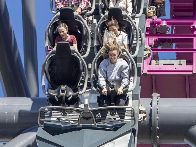 GOLD COAST, AUSTRALIA - JULY 15: Guests enjoy a roller coaster ride at Warner Bros. Movie World on July 15, 2020 in Gold Coast, Australia. Movie World has reopened to the public with extra safety and hygiene measures in place following its temporary closure on 23 March 2020 due to the COVID-19 pandemic. Visitors to Movie World must observe physical distancing rules and provide details for contact tracing purposes. Increased sanitisation of high touch areas throughout the park has been introduced along with contactless payments. (Photo by Jono Searle/Getty Images)