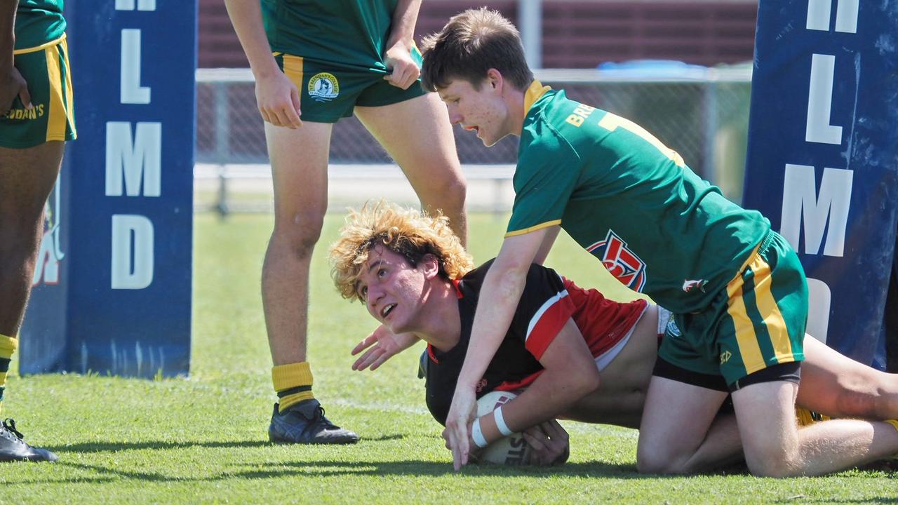 A Kirwan State High School player is tackled by St Brendan's College players in Mackay on Wednesday, August 24, 2022.