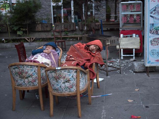 Residents fearing aftershocks sleep outside of their homes after an earthquake in Zhangzha in southwest China’s Sichuan province on August 10, 2017. The 6.5-magnitude earthquake struck Sichuan province late on August 8, tearing cracks in mountain highways, triggering landslides, damaging buildings and sending panicked residents and tourists fleeing into the open. Picture: AFP