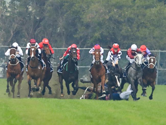 Andrew Adkins finds himself under flaying hooves as Hot ‘N’ Hazy falls in the home straight at Rosehill Gardens last month. Picture: Getty Images