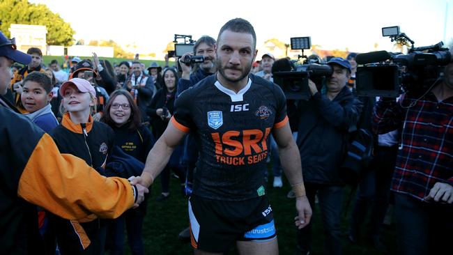 Robbie Farah being mobbed by fans and media after playing reserve grade for Wests Tigers.