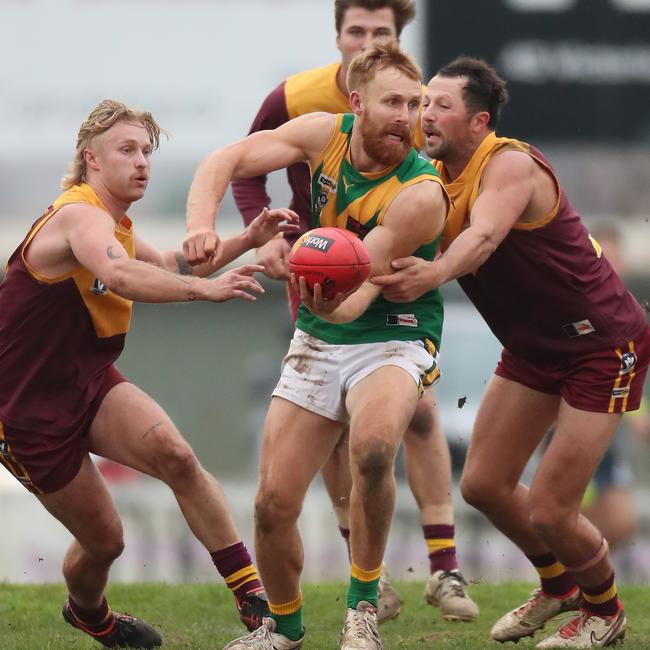 Drouin pair Jack Fraser and Tim Hancock close in on Leongatha’s Luke Bowman.