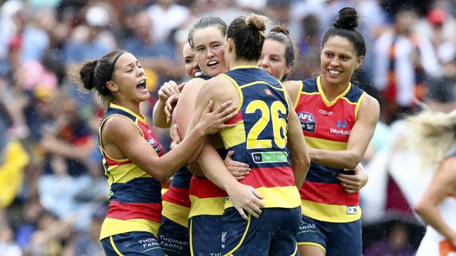 Sarah Perkins mobbed by jubilant teammates after kicking a goal. Picture: Sarah Reed