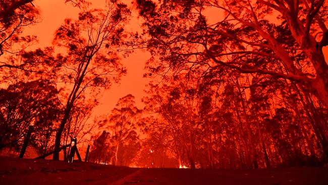 The afternoon sky glows red from bushfires in the area around the town of Nowra on December 31. Picture: AFP