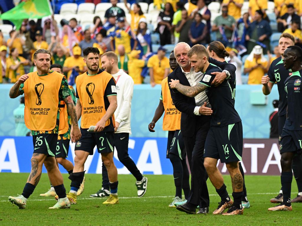 Australia's coach Graham Arnold and midfielder Riley McGree celebrate after defeating Tunisia 1-0. Picture: AFP