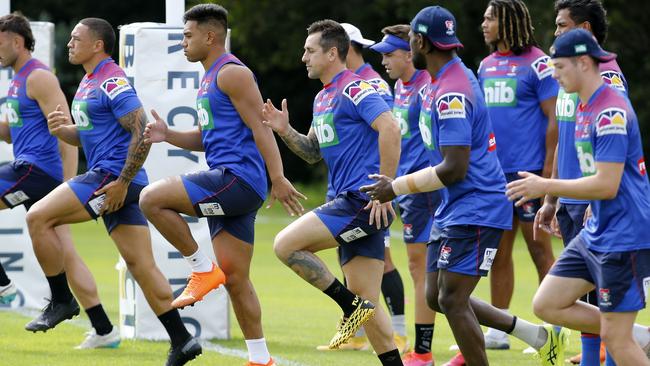 Mitchell Pearce, centre, warms up during a Knights training session on Thursday Picture: AAP