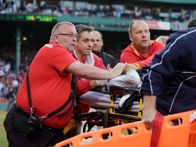 Boston Red Sox medical personnel tend to a woman, who with was hit by a wooden shard, off a broken bat.