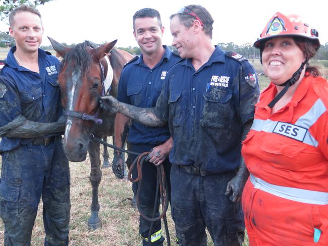 Happy rescuers: Moose with firefighters Shane Park, Michael Cronin, Barry Jones and Hawkesbury SES member Megan Thomson after the three-hour rescue effort. Picture: Fire and Rescue NSW