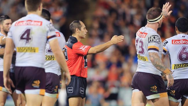 Referee Ashley Klein signals for a penalty to the Broncos in golden point extra time during the round three NRL match between the Wests Tigers and the Brisbane Broncos.