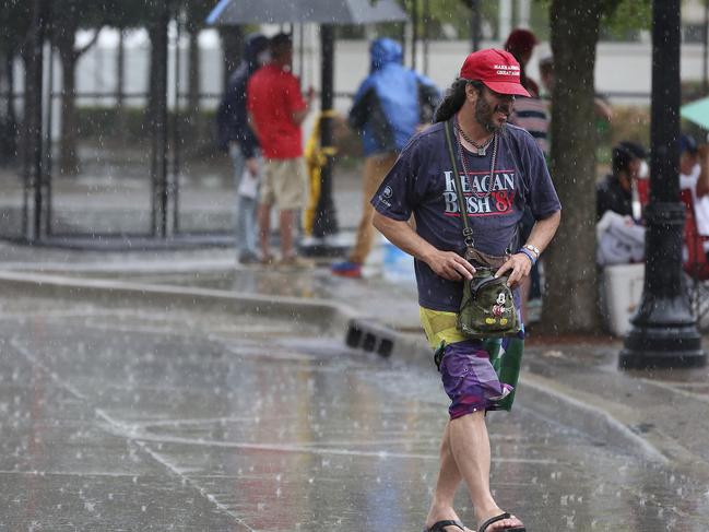 A heavy rain falls as Trump supporters line up and camp. Picture: AP