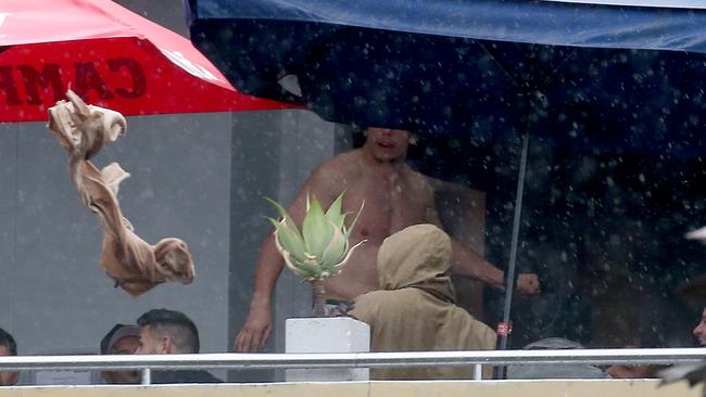 A Canterbury-Bankstown Bulldogs players rips off his shirt and throws it over the balcony. Picture: Toby Zerna