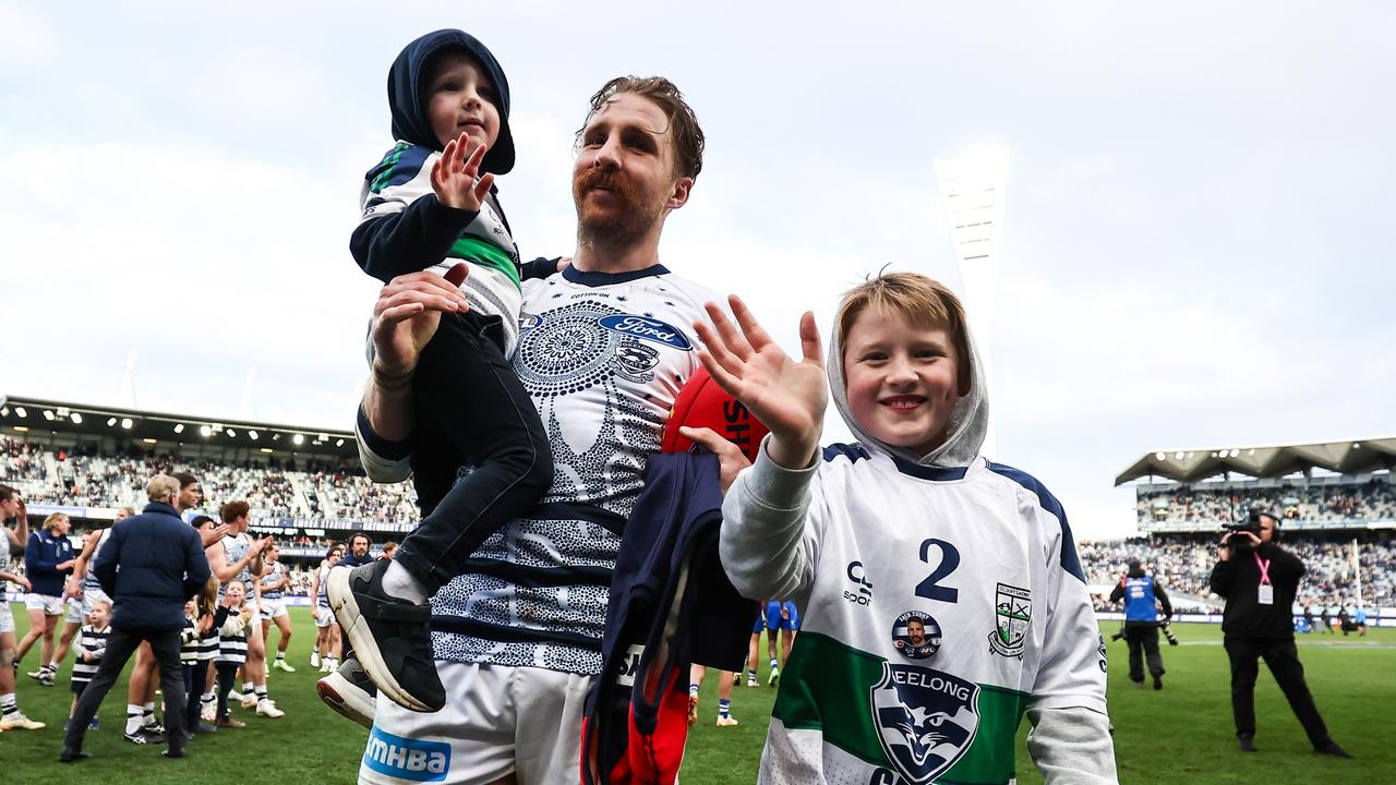 GEELONG, AUSTRALIA - JULY 09: Zach Tuohy of the Cats receives a guard of honour as he leaves the field with his children Flynn and Rafferty during the 2023 AFL Round 17 match between the Geelong Cats and the North Melbourne Kangaroos at GMHBA Stadium on July 9, 2023 in Geelong, Australia. (Photo by Dylan Burns/AFL Photos via Getty Images)