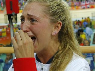 Britain's Laura Trott (R) reacts next to her fiance Britain's Jason Kenny after he won the Men's Keirin finals track cycling event at the Velodrome during the Rio 2016 Olympic Games in Rio de Janeiro on August 16, 2016. / AFP PHOTO / Odd ANDERSEN