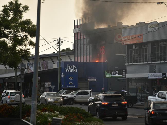 Smoke was visible throughout the Grafton CBD as the blaze continued from above the Forty Winks store. Photo: Adam Hourigan