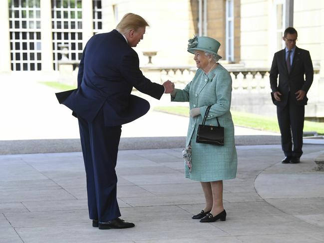 Britain's Queen Elizabeth II greets President Donald Trump as he arrives for a welcome ceremony in the garden of Buckingham Palace, in London. Picture: AP