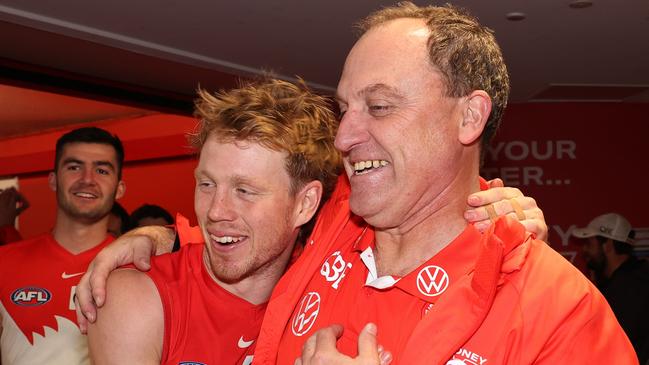 SYDNEY, AUSTRALIA - JULY 13:  Swans head coach John Longmire celebrates with Callum Mills of the Swans after victory during the round 18 AFL match between Sydney Swans and Western Bulldogs at Sydney Cricket Ground, on July 13, 2023, in Sydney, Australia. (Photo by Mark Metcalfe/AFL Photos/via Getty Images)