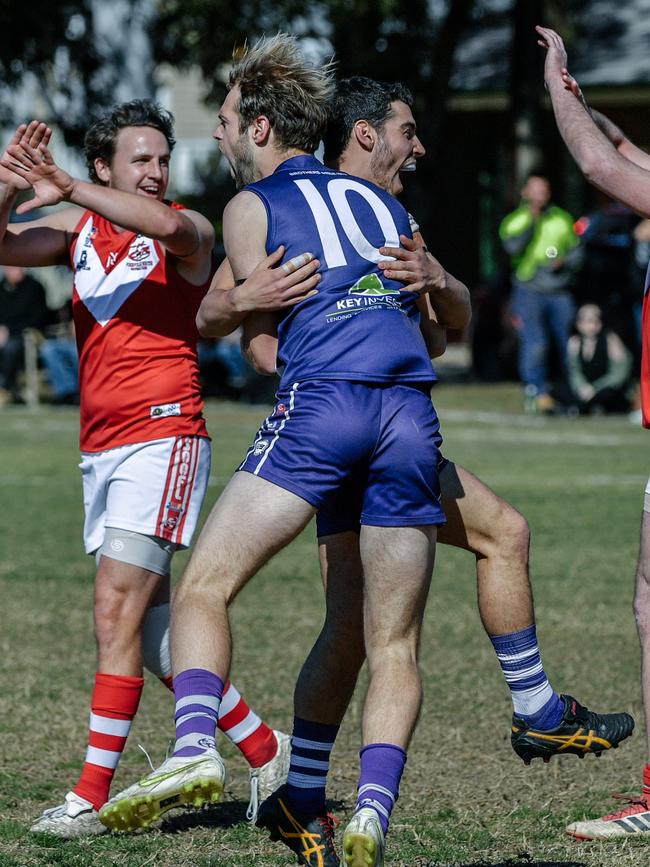 Josef Builder and Matthew Raymond celebrate a goal in CBC Old Collegians’ 2018 grand final win. The Dolphins are in the big dance for the second year in a row. Picture: AAP/Morgan Sette