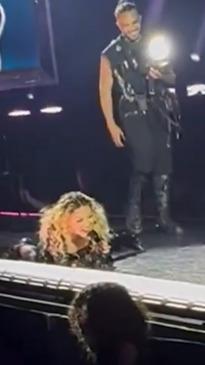 Madonna falls on stage after dancer drops her