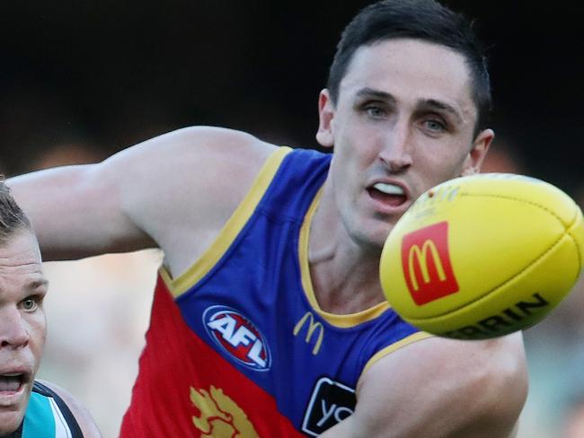 ADELAIDE, AUSTRALIA - MARCH 18: Dan Houston of the Power and Oscar McInerney of the Lions during the 2023 AFL Round 01 match between the Port Adelaide Power and the Brisbane Lions at Adelaide Oval on March 18, 2023 in Adelaide, Australia. (Photo by Sarah Reed/AFL Photos via Getty Images)