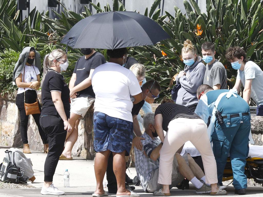 Paramedics tend to a person who fainted while in line for Covid testing at the Royal Brisbane and Women's Hospital in Brisbane. Picture: NCA NewsWire/Tertius Pickard