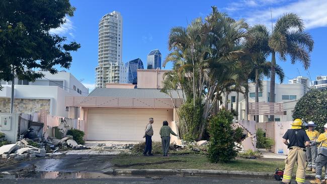 Owners of the property survey the damage after the car was towed. Picture: Tahlia Leathart.