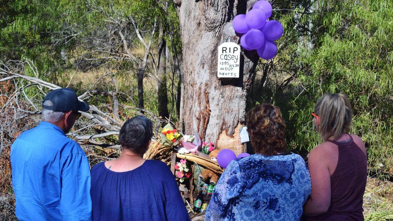 The Thompson and Porter families pay tribute to their sons at the memorial site of the crash on Chinchilla Tara Road Pic: Peta McEachern