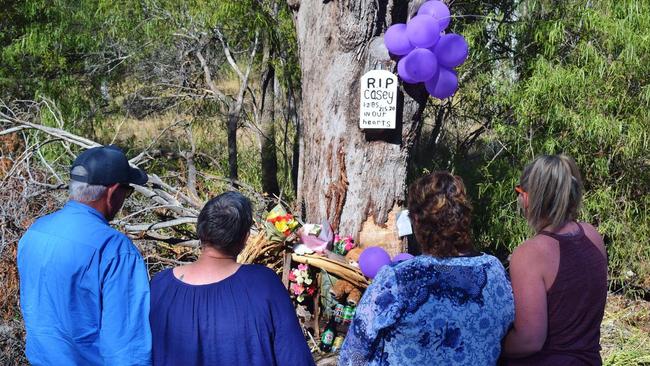 The Thompson and Porter families pay tribute to their sons at the memorial site of the crash on Chinchilla Tara Road Pic: Peta McEachern