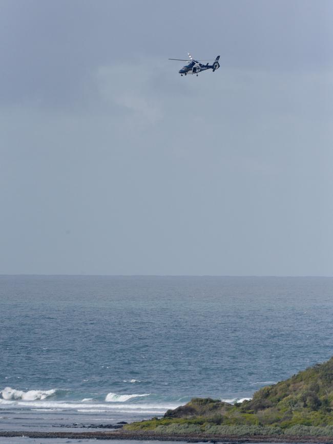 A helicopter searches for the two men. Picture: Andrew Henshaw