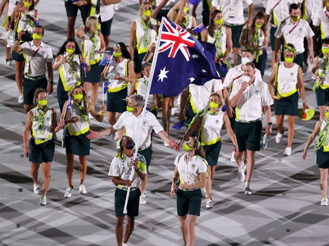 TOKYO, JAPAN - JULY 23: Flag bearers Cate Campbell and Patty Mills of Team Australia lead their team in during the Opening Ceremony of the Tokyo 2020 Olympic Games at Olympic Stadium on July 23, 2021 in Tokyo, Japan. (Photo by Clive Brunskill/Getty Images)