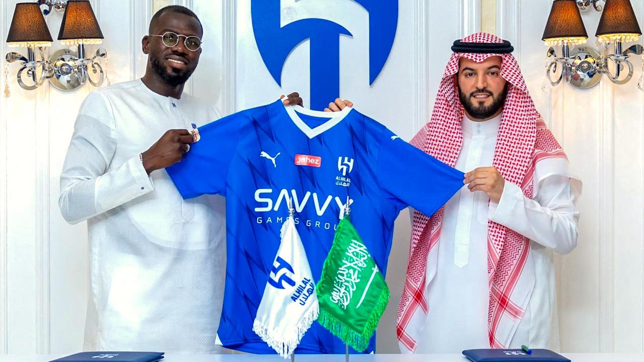 In this handout picture release by the Saudi Al-Hilal football club on June 25, 2023, Senegalese Kalidou Koulibaly (L) poses for a picture at the Al-Hilal stadium in Riyadh.