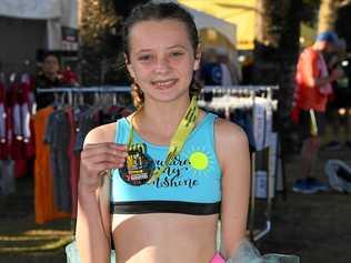 STAR WILL SHINE BRIGHTER: Loghan Gonzales shows off her medal after she finished first Sunshine Coast Marathon. Picture: Warren Lynam