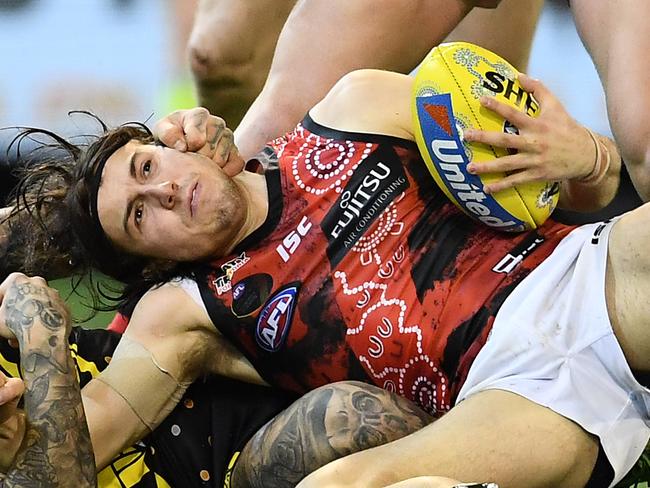 MELBOURNE, AUSTRALIA - MAY 25: Dustin Martin of the Tigers tackles Andrew McGrath of the Bombers during the round 10 AFL match between the Richmond Tigers and the Essendon Bombers at Melbourne Cricket Ground on May 25, 2019 in Melbourne, Australia. (Photo by Quinn Rooney/Getty Images)